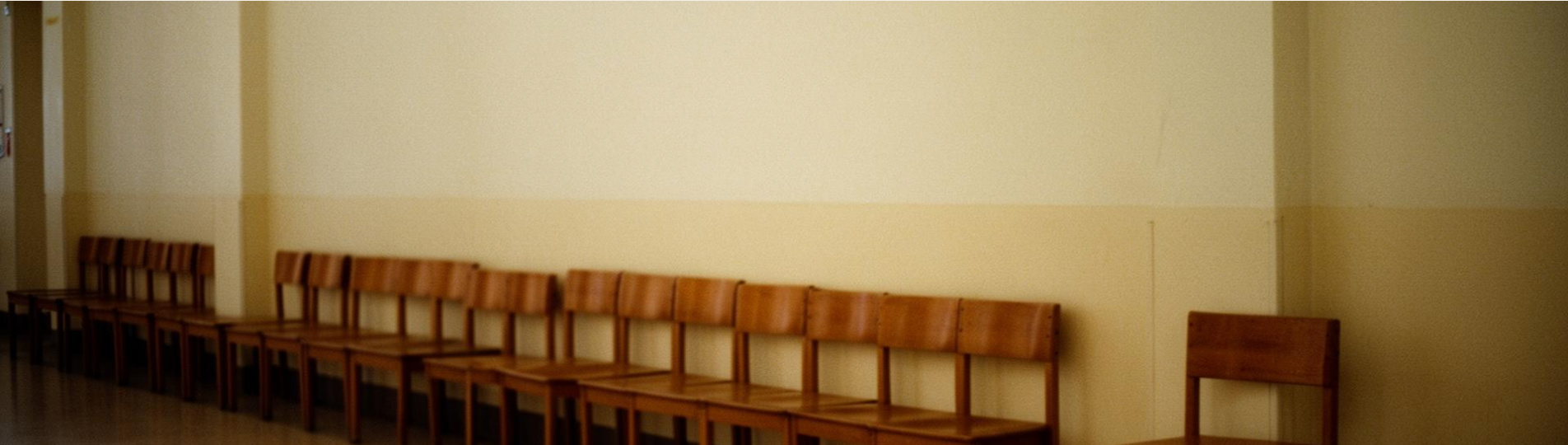 A long hallway lined with chairs.